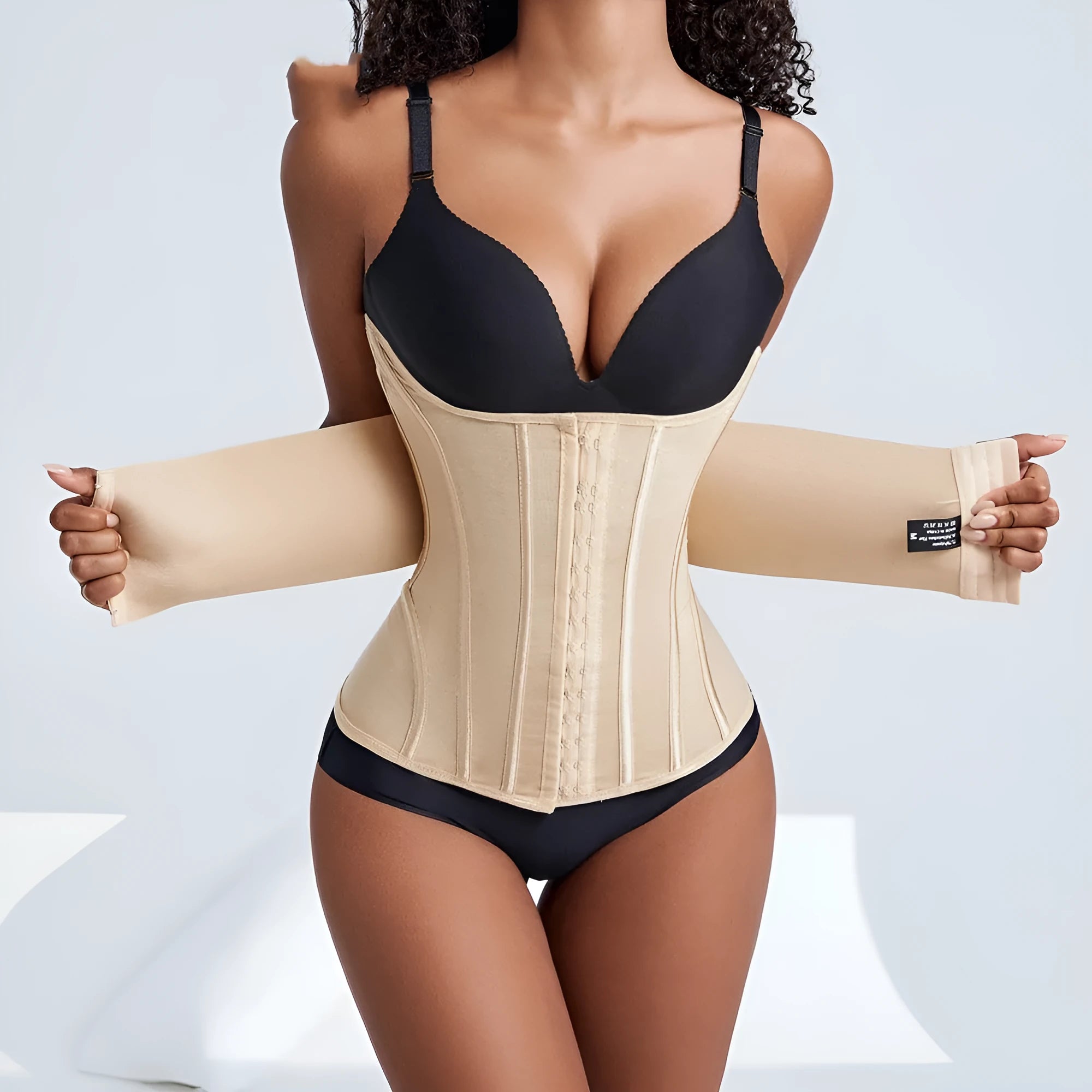 Nylon belly band waist trainer in black or apricot colour with an adjustable belt tie.