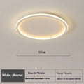 Minimalist round LED ceiling lamp in black finish with dimmable tricolour light, shown in a bedroom setting.