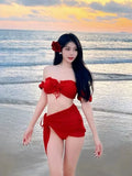 Red women's bikini swimsuit with puff sleeve top and skirt bottom