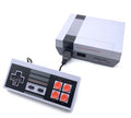 Compact black retro NES game console with two classic controllers on a stand.