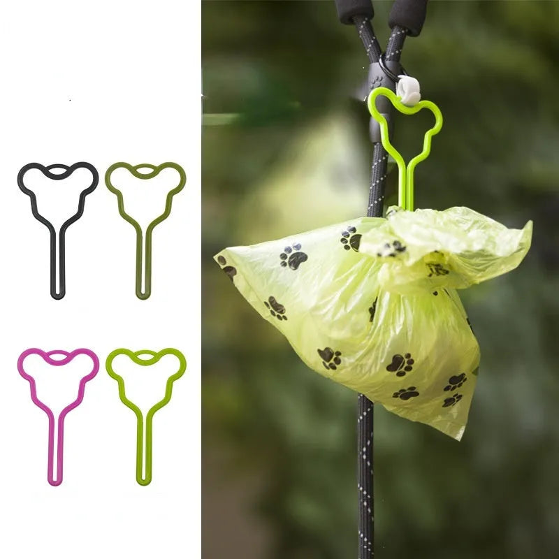 A coloured dog poop bag holder with a Velcro strap attached to a dog lead.