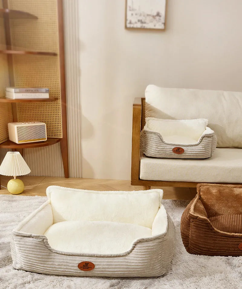 Coffee and white coloured removable washable dog kennel bed shown in small and medium sizes on a sofa and floor.