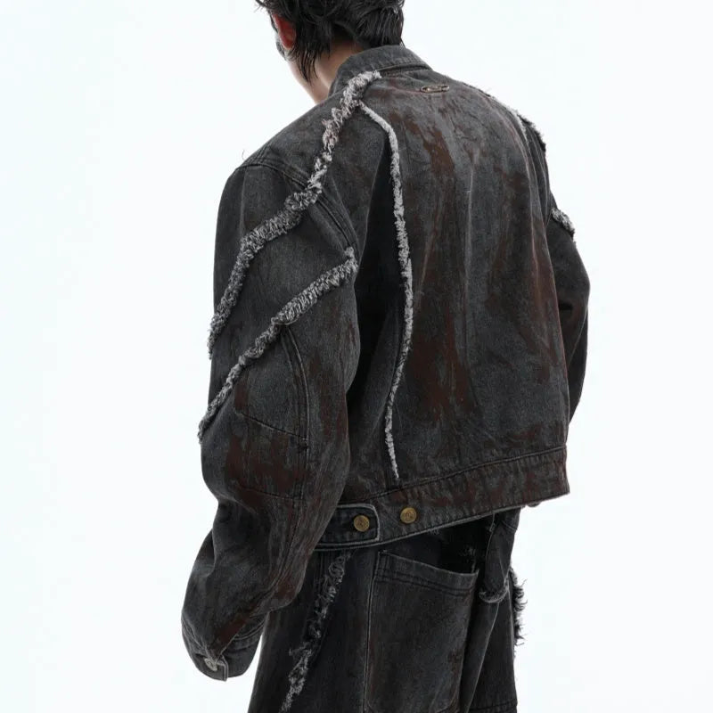 Distressed black denim coat with padded shoulders, gradient splash-dye pattern and matching trousers laid flat