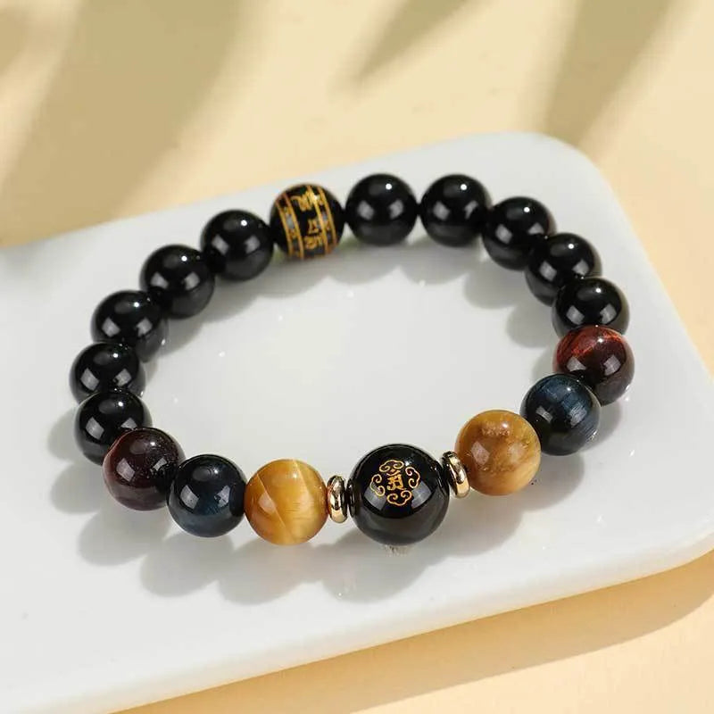 Manually crafted black agate beaded bracelet with gold, blue, and red tiger eye stones, showing ethnic zodiac design.