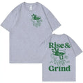 Men's loose fit black t-shirt featuring a green 'Rise and Grind Green Coffee' cartoon graphic print.