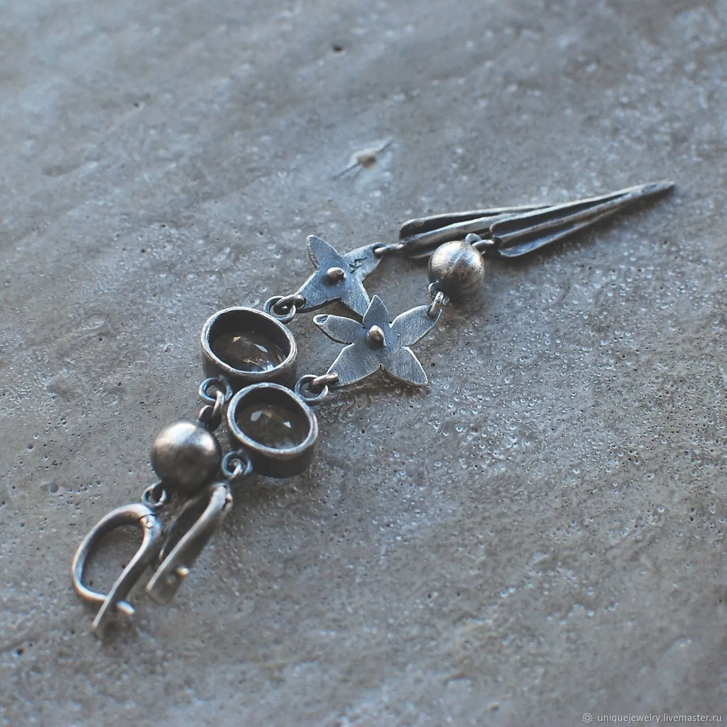 Geometric antique silver pendant earrings with rhinestone accents and long drop design