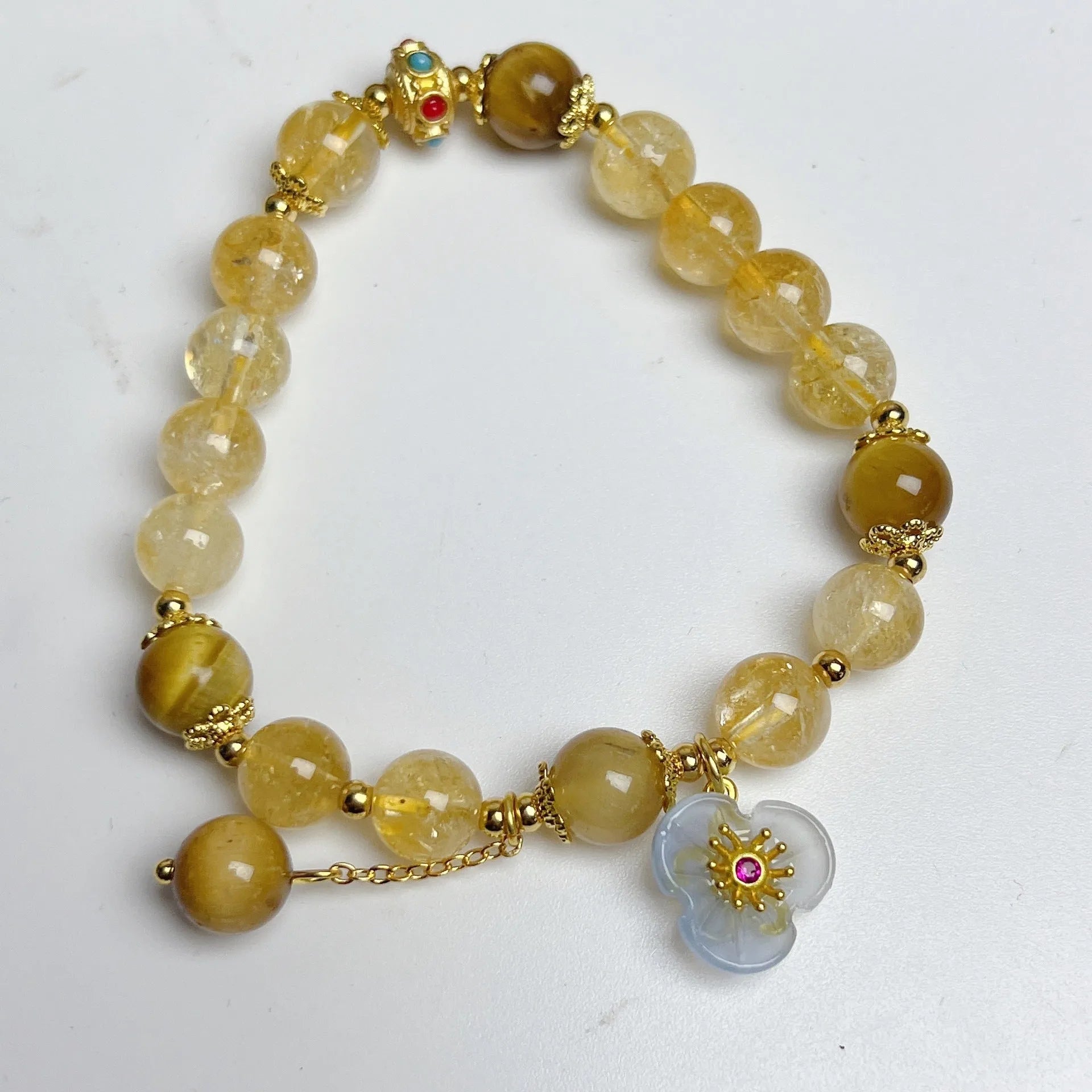 Handmade citrine colour crystal bracelet with floral and tassel detailing for women.