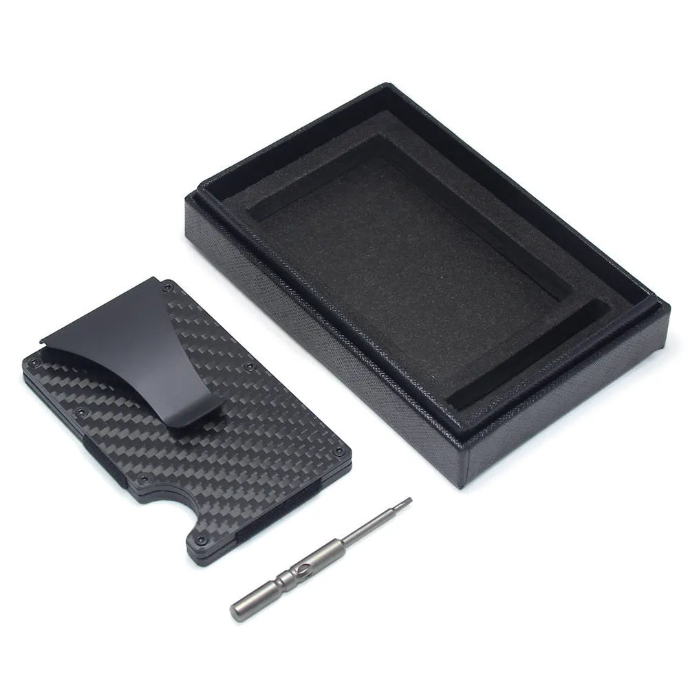 Geometric carbon fibre and aluminium business card holder, 8mm thick, on a table.