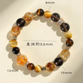 Close-up of a women's natural yellow bracelet with 10mm round artificial crystal beads on a string.