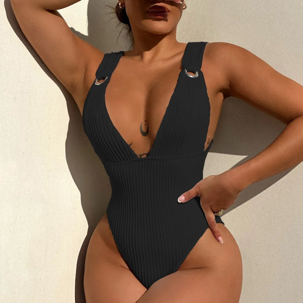 A solid colour one-piece swimsuit for women with a v-neck and adjustable side ties, shown in black.