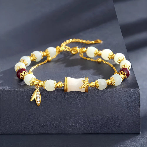 Bamboo style bracelet with electroplated coloured glass beads in a Ruyi flower design.