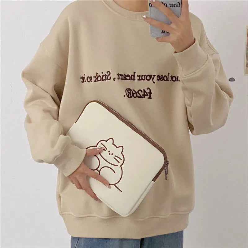 Embroidered cat design nylon tablet protective sleeve with zipper closure.