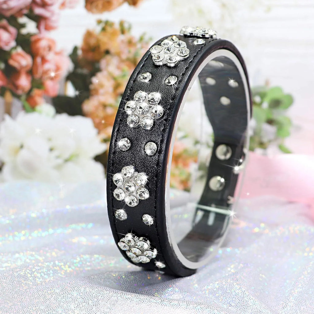 Soft black PU leather dog collar with sparkling pink rhinestone flower studs and a metal D-ring.