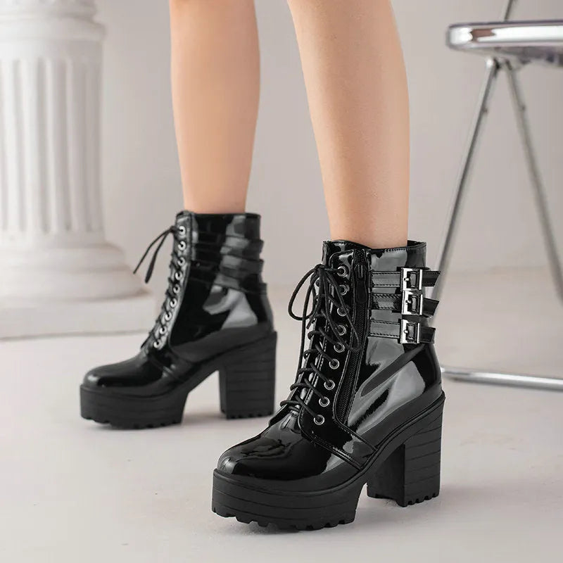 Women's black thick-heeled lace-up ankle boots with a round toe and waterproof platform sole.