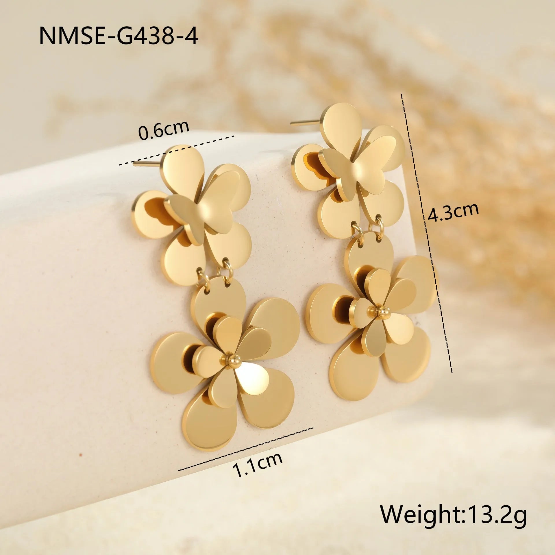 Gold flower butterfly earrings for women with geometric design on stainless steel.