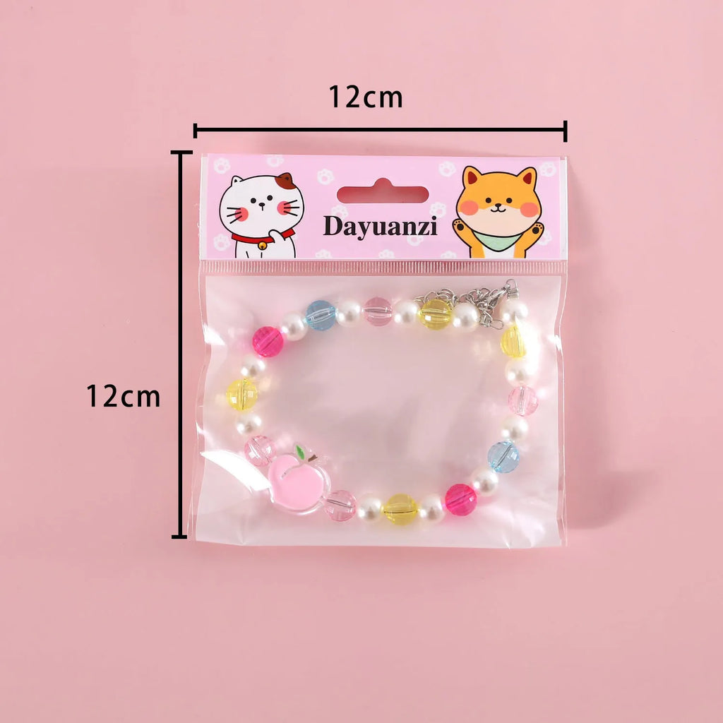 Colourful plastic bead cat necklace in small flower, rainbow or peach designs with adjustable sizing