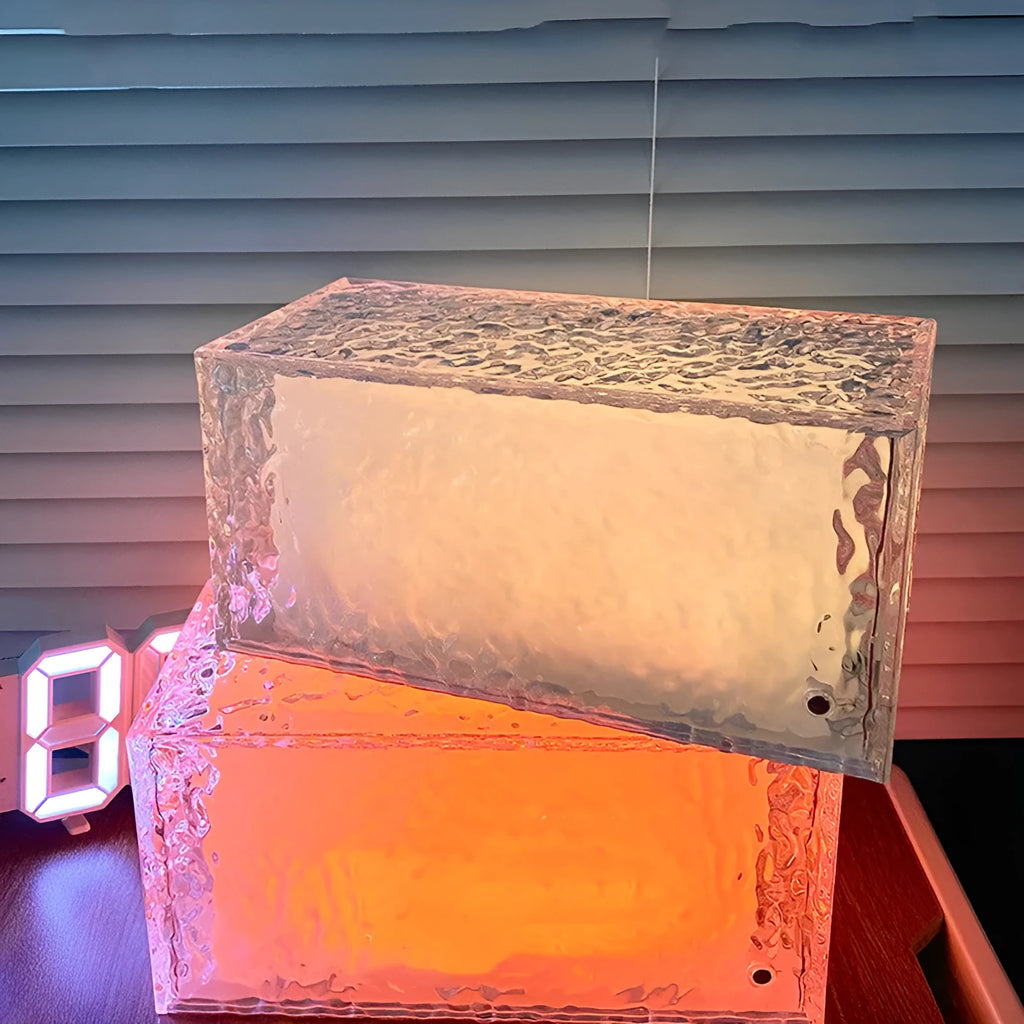 Geometric acrylic ice cube night light with colour changing LEDs on bedside table