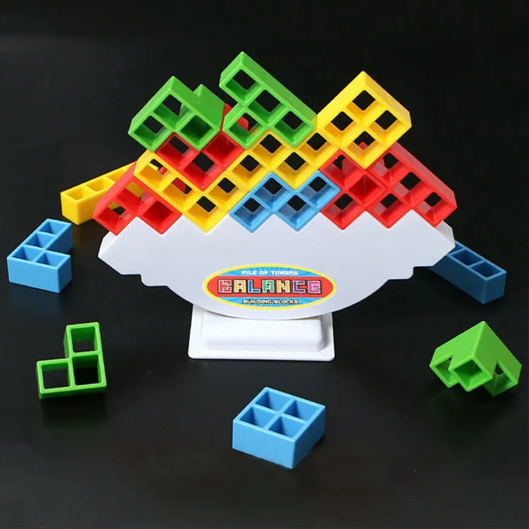 Plastic balance stacking board game with 16 colourful blocks, chassis, and base on a table.