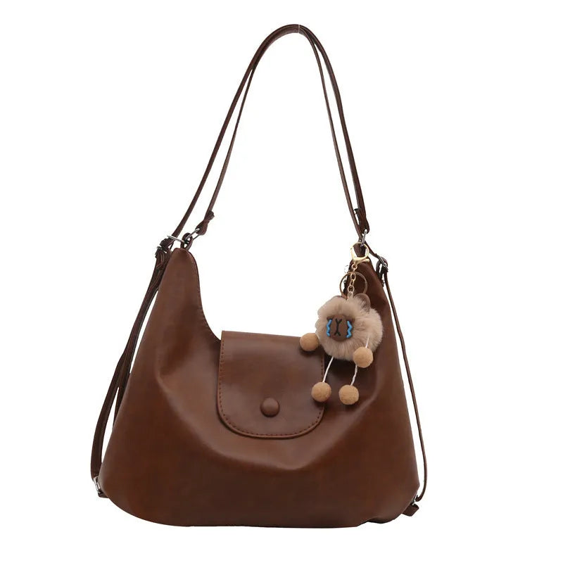 PU leather commuter backpack in horizontal square shape with single shoulder strap