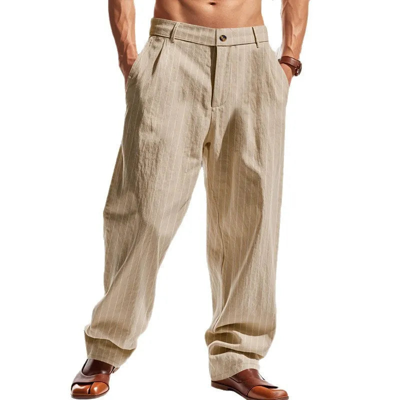 Man wearing beige striped linen trousers with a high waist and wide loose legs.