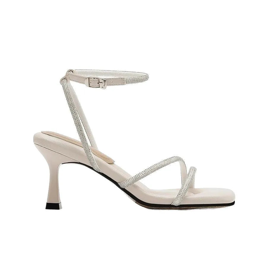 Women's silver square toe rhinestone ankle strap high heel sandals on a white background.