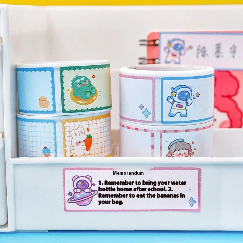 Roll of colourful cartoon name tape stickers showing Dinosaur, Astronaut, Rabbit, and Girl designs