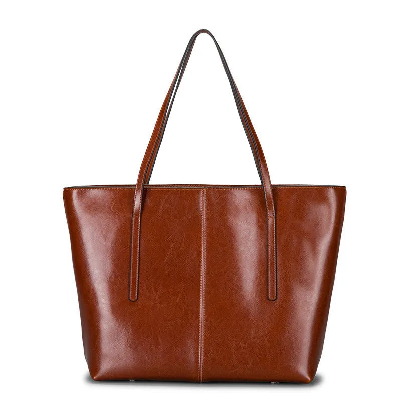 Women's retro style cowhide shoulder bag in horizontal square shape with multiple internal compartments