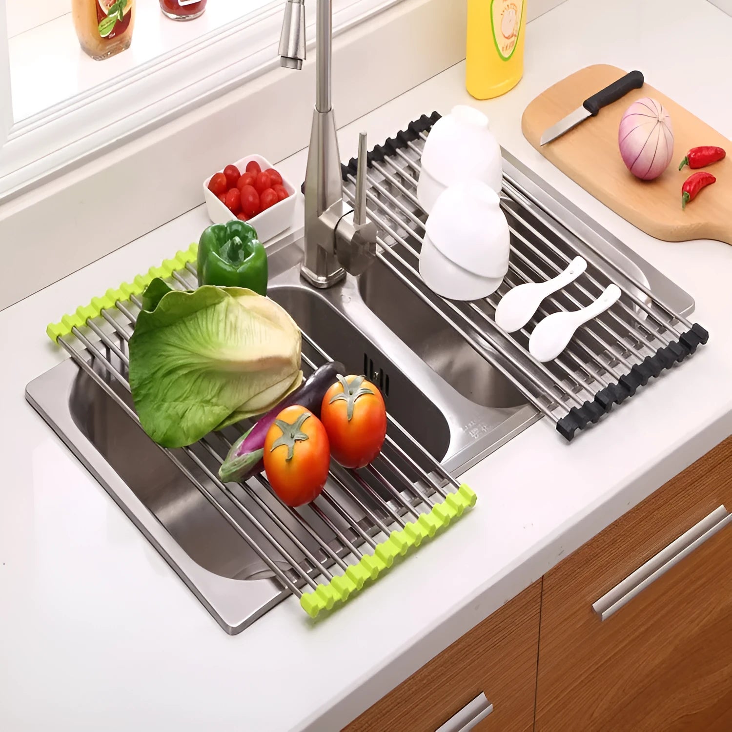 Stainless steel folding kitchen drain rack with plastic tubes in a kitchen sink