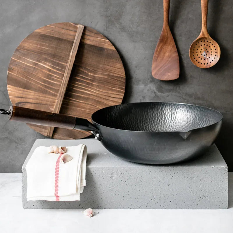 Traditional black iron wok with wooden handle showing 40cm diameter cooking surface