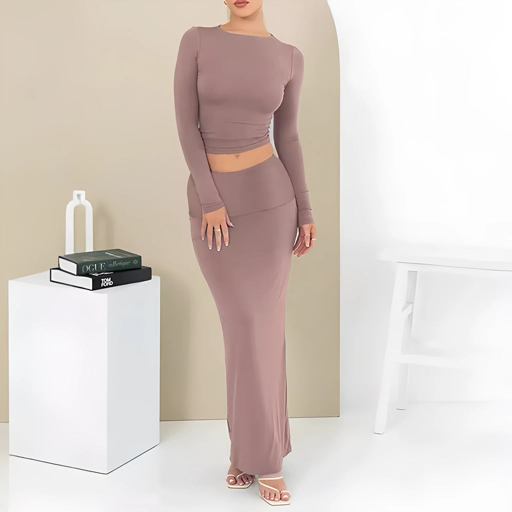 Women's slim fit polyester two-piece suit set with top, long skirt, and exposed navel detail.