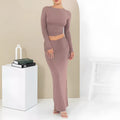 Women's slim fit polyester two-piece suit set with top, long skirt, and exposed navel detail.