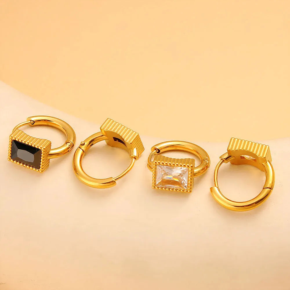 A pair of square geometric zircon stainless steel earrings on a white background.