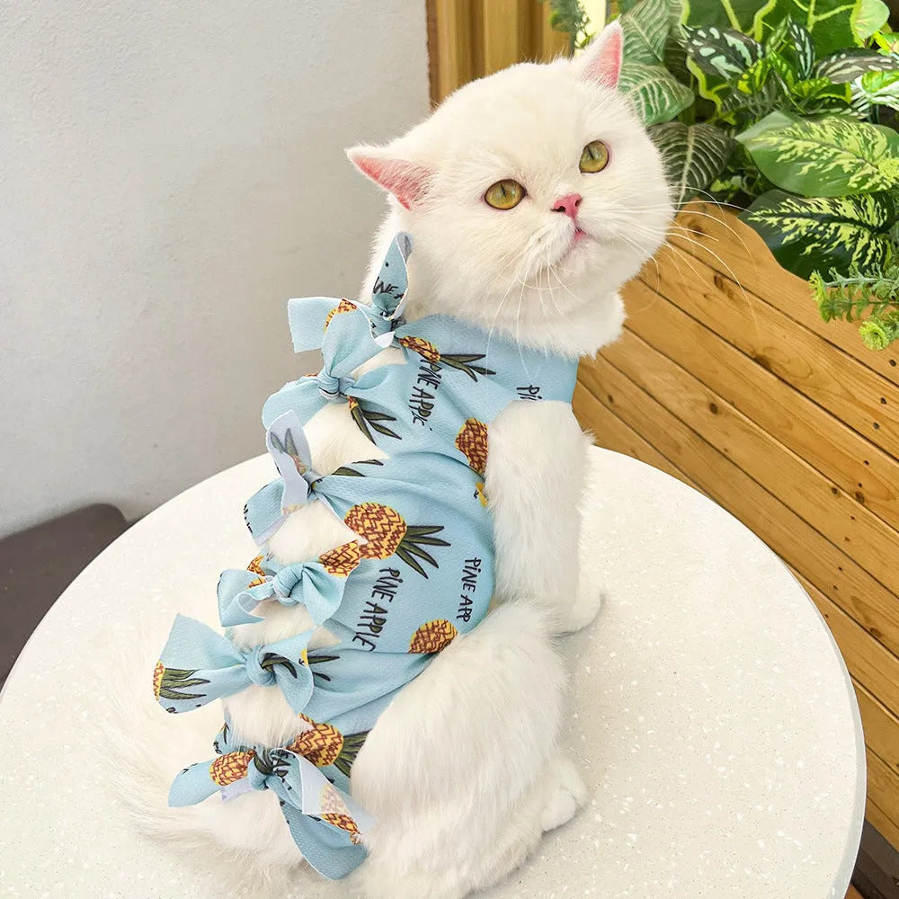 Lace-up cat sterilisation clothing in pink on a cat, showing the adjustable ties and full-body coverage.