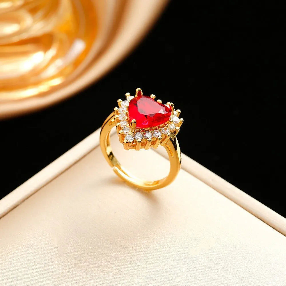 Gold red titanium steel jewellery set with hearts flower pendant, necklace, stud earrings, and ring.