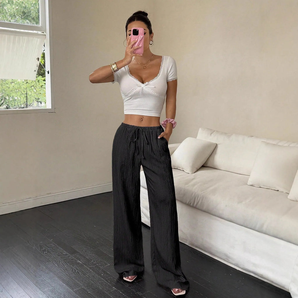 Black wide leg women's trousers with a lace-up detail on the mid waist