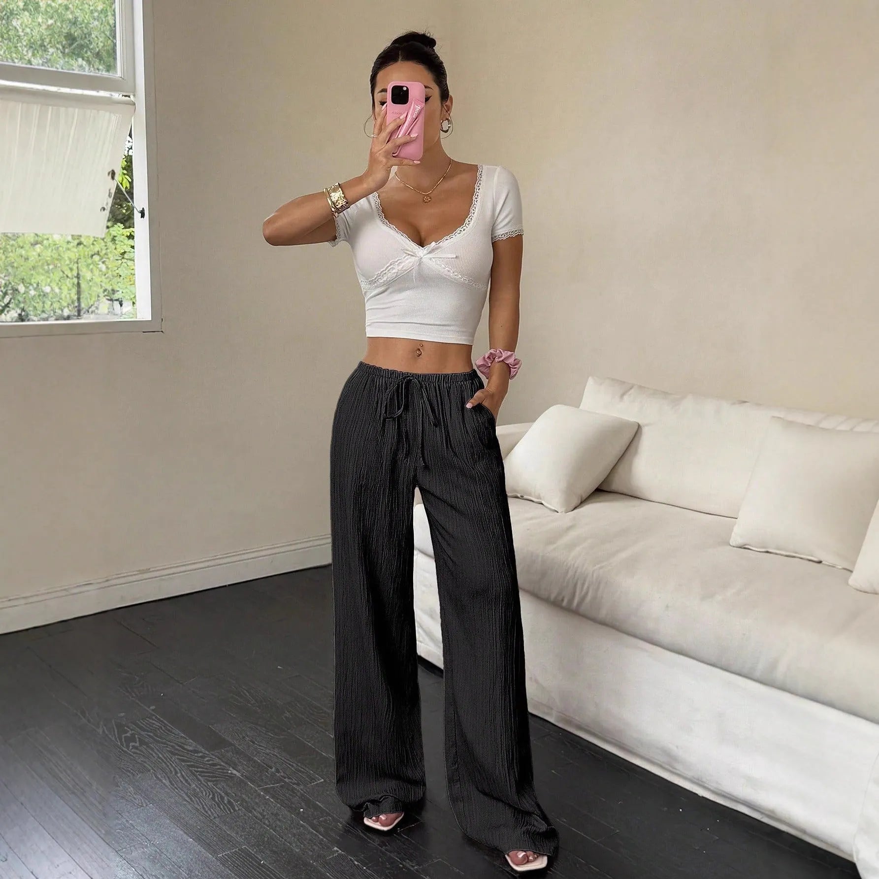 Black wide leg women's trousers with a lace-up detail on the mid waist