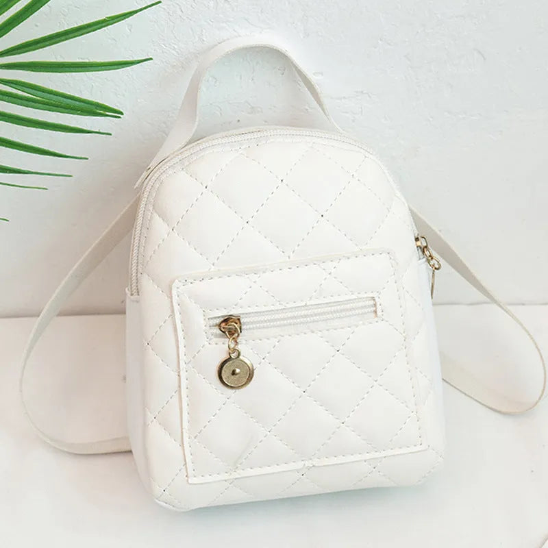 Small white embroidered hardback girls' backpack in a vertical square shape on a plain background.