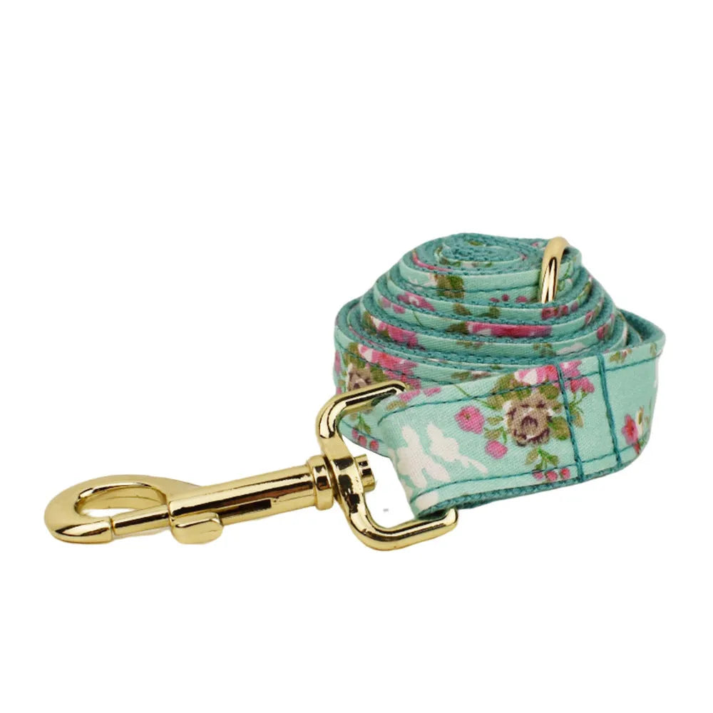 Rose print fabric dog collar set with green detachable bow, leash, and vest for pets
