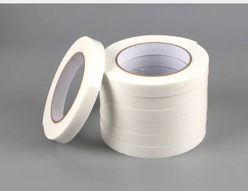 Roll of white foam double-sided adhesive tape showing its thickness, with size options 15mm, 18mm, and 30mm wide.