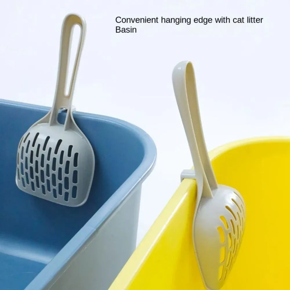 Grey plastic cat litter scoop standing upright in its matching storage base.