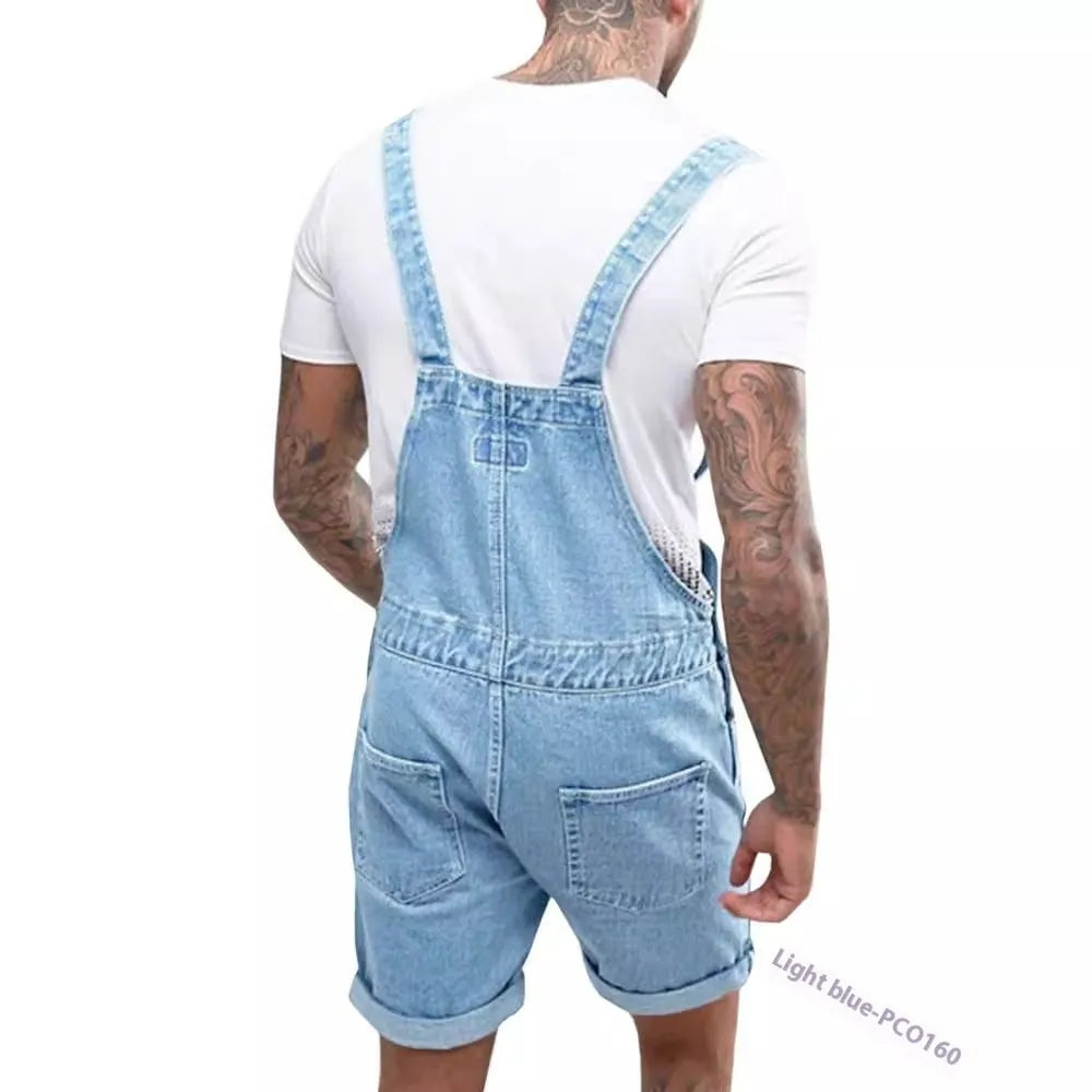 A pair of black denim suspender pants with a mid waist, zipper fly, and straight leg shorts cut on a mannequin.