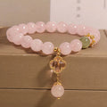 Pink crystal four-leaf clover pendant bracelet with alloy setting and rhinestone details