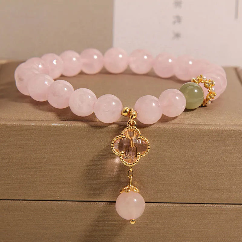Pink crystal four-leaf clover pendant bracelet with alloy setting and rhinestone details