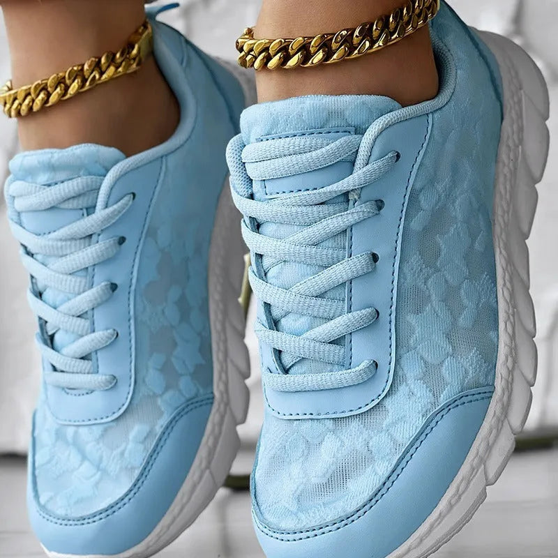 Women's white canvas casual sports running shoes with a flat heel and round toe on a plain background.