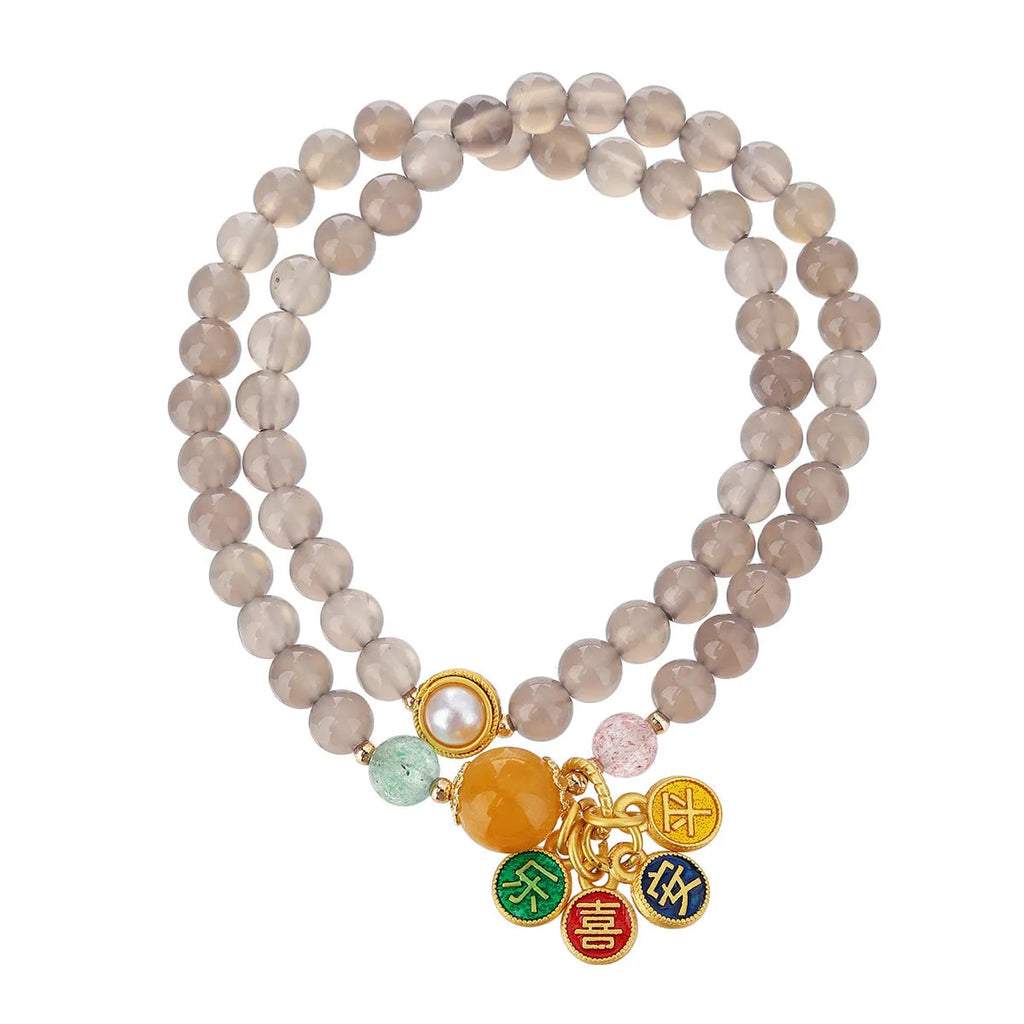 Natural gray agate two-circle bracelet on an adjustable cord, showing hand-polished stone detail.