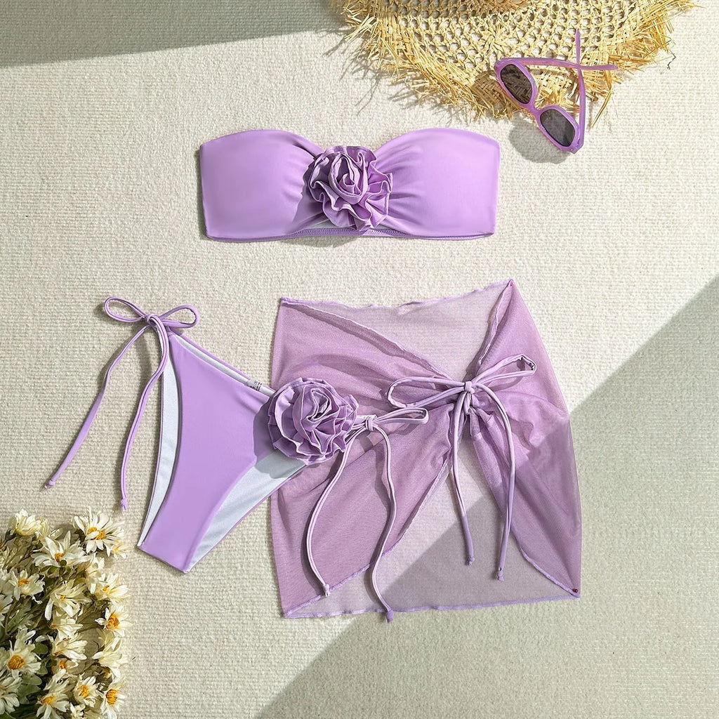Women's pink tube top swimsuit with a tied flower design, including matching pants and skirt.