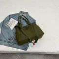 Polyester shoulder tote bag in solid colour with external sandwich pocket and internal phone pouch.