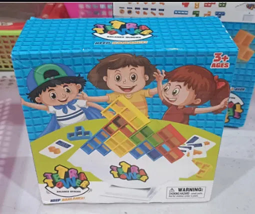 Plastic balance stacking board game with 16 colourful blocks, chassis, and base on a table.