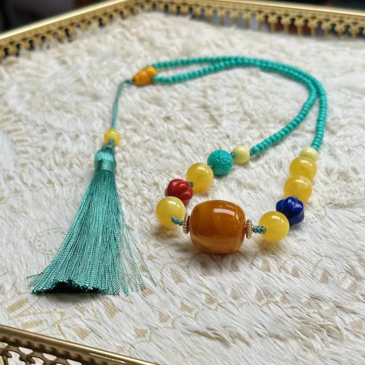 Turquoise hand-woven mesh flower lucky pendant on a long, adjustable ball bead necklace chain.
