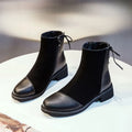 Women's black Martin boots with side zipper, non-slip rubber soles, and decorative bow detailing